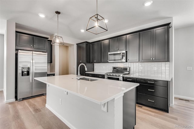3314 N Haleyville Ct, Aurora, CO 80019 - kitchen with appliances with stainless steel finishes, a sink, light wood-style floors, baseboards, and decorative backsplash