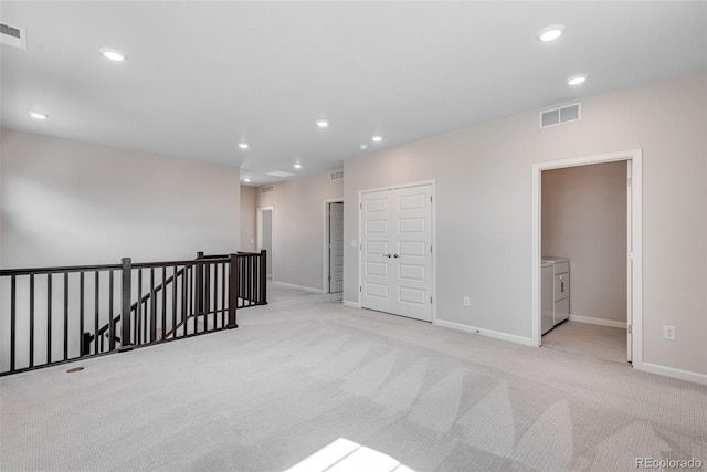 3314 N Haleyville Ct, Aurora, CO 80019 - spare room featuring washer and dryer, light carpet, recessed lighting, and baseboards