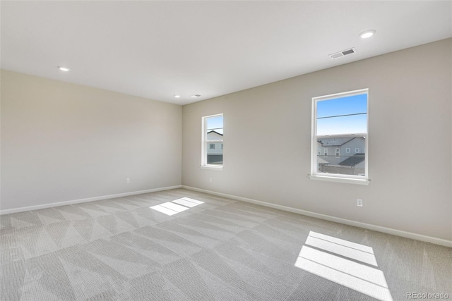 3314 N Haleyville Ct, Aurora, CO 80019 - spare room featuring light carpet, baseboards, and recessed lighting