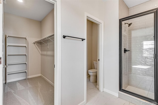 3314 N Haleyville Ct, Aurora, CO 80019 - full bathroom featuring toilet, a walk in closet, a stall shower, marble finish flooring, and baseboards