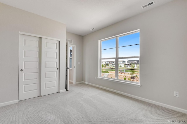 3314 N Haleyville Ct, Aurora, CO 80019 - unfurnished bedroom with light colored carpet, baseboards, and a closet