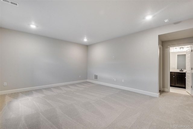 3314 N Haleyville Ct, Aurora, CO 80019 - empty room featuring light colored carpet, baseboards, recessed lighting, and a sink
