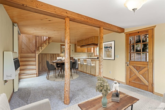 109 Cutforth Rd, Black Hawk, CO 80422 - living area with heating unit, stairway, light carpet, and a wooden ceiling with exposed beams
