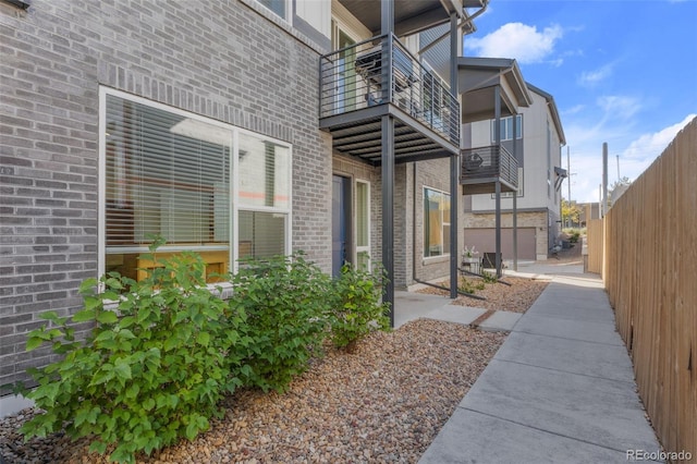 exterior space with brick siding and fence