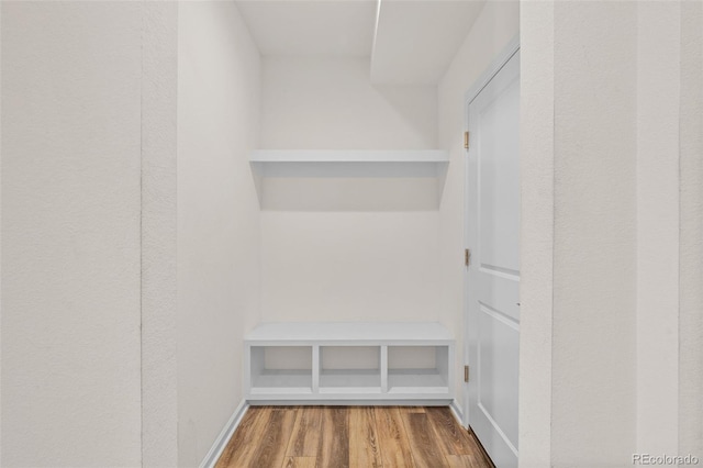 mudroom featuring wood finished floors and baseboards