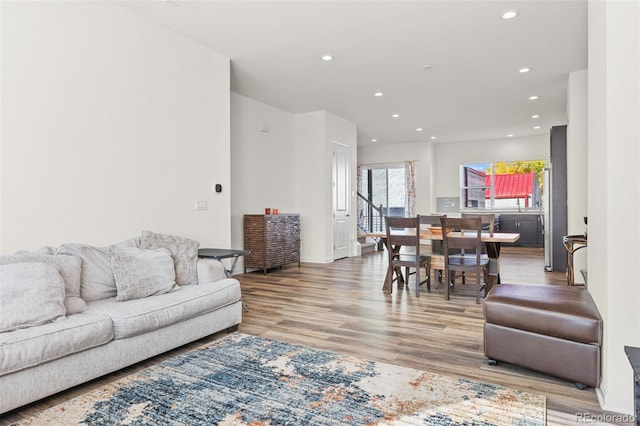 living area with wood finished floors and recessed lighting