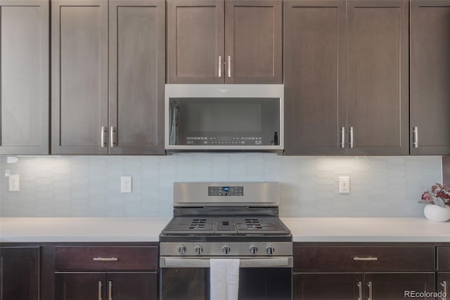 kitchen featuring dark brown cabinetry, stainless steel appliances, and light countertops