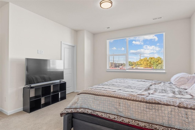 bedroom with light carpet, baseboards, and visible vents