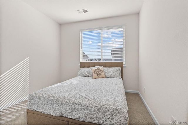 bedroom with baseboards, visible vents, and carpet flooring