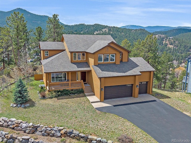 3173 Gold Yarrow Ln, Evergreen, CO 80439 - view of front of property with a porch, driveway, and a mountain view