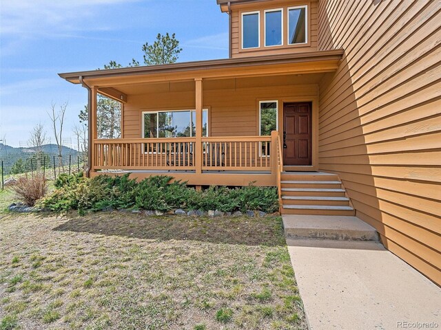 3173 Gold Yarrow Ln, Evergreen, CO 80439 - property entrance featuring covered porch and a mountain view