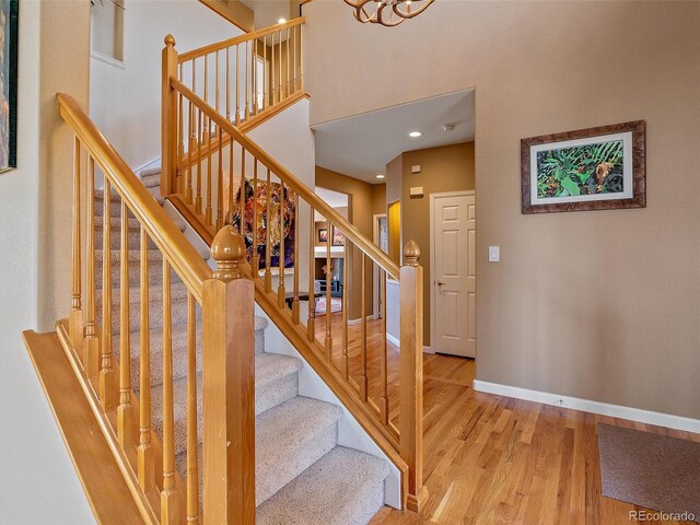 3173 Gold Yarrow Ln, Evergreen, CO 80439 - stairway with recessed lighting, wood finished floors, a high ceiling, and baseboards