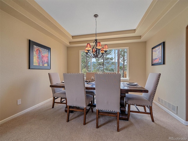 3173 Gold Yarrow Ln, Evergreen, CO 80439 - dining space with a raised ceiling, carpet, visible vents, and an inviting chandelier