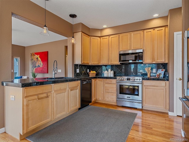 3173 Gold Yarrow Ln, Evergreen, CO 80439 - kitchen with light brown cabinetry, tile countertops, a sink, a peninsula, and appliances with stainless steel finishes