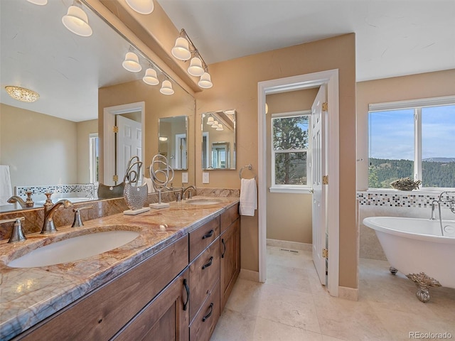 3173 Gold Yarrow Ln, Evergreen, CO 80439 - full bath featuring a soaking tub, tile patterned flooring, a sink, and double vanity