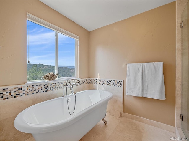 3173 Gold Yarrow Ln, Evergreen, CO 80439 - bathroom featuring tile patterned flooring and a freestanding tub