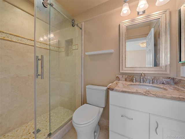3173 Gold Yarrow Ln, Evergreen, CO 80439 - bathroom featuring toilet, vanity, and a stall shower