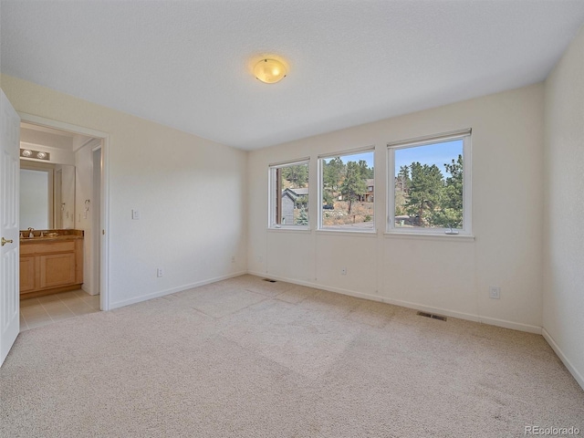 3173 Gold Yarrow Ln, Evergreen, CO 80439 - unfurnished bedroom with baseboards, visible vents, light colored carpet, and a sink