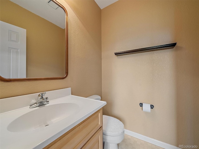 3173 Gold Yarrow Ln, Evergreen, CO 80439 - bathroom featuring baseboards, toilet, and vanity