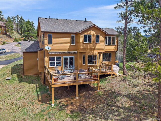 3173 Gold Yarrow Ln, Evergreen, CO 80439 - rear view of property featuring a lawn, a deck, and a shingled roof