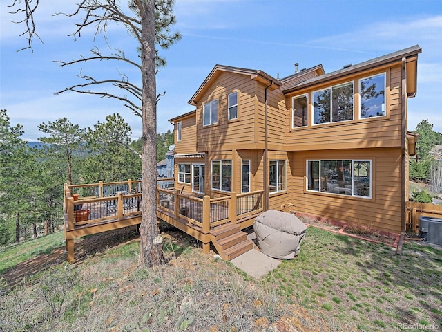 3173 Gold Yarrow Ln, Evergreen, CO 80439 - back of property featuring a wooden deck and central air condition unit