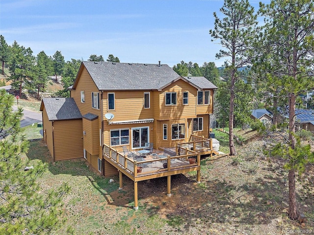 3173 Gold Yarrow Ln, Evergreen, CO 80439 - rear view of property featuring a wooden deck and roof with shingles
