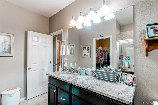 25120 E Maple Pl, Aurora, CO 80018 - full bath featuring a shower stall, vanity, and a walk in closet
