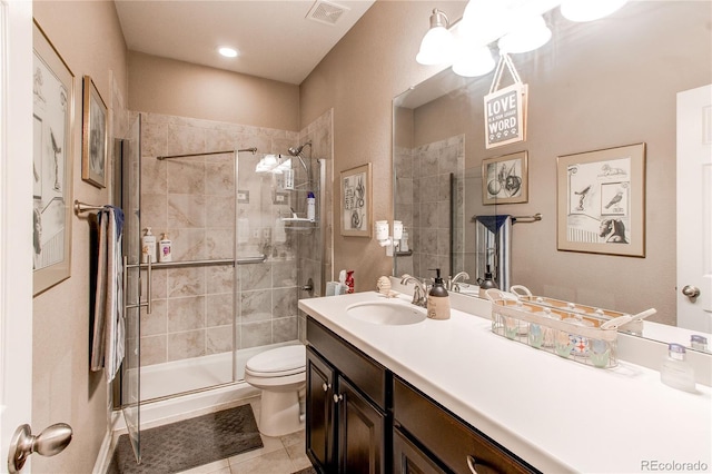25120 E Maple Pl, Aurora, CO 80018 - bathroom featuring toilet, vanity, tile patterned floors, and a shower stall