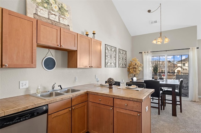 kitchen featuring dishwasher, a sink, a chandelier, high vaulted ceiling, and light carpet