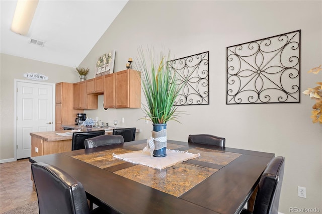 dining area featuring visible vents, baseboards, and high vaulted ceiling