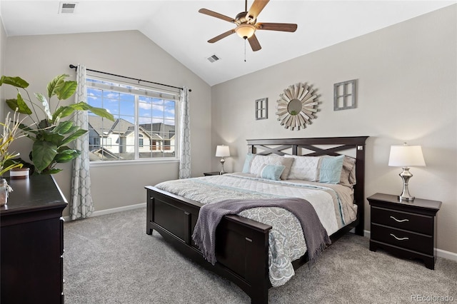 bedroom featuring vaulted ceiling, light colored carpet, and visible vents