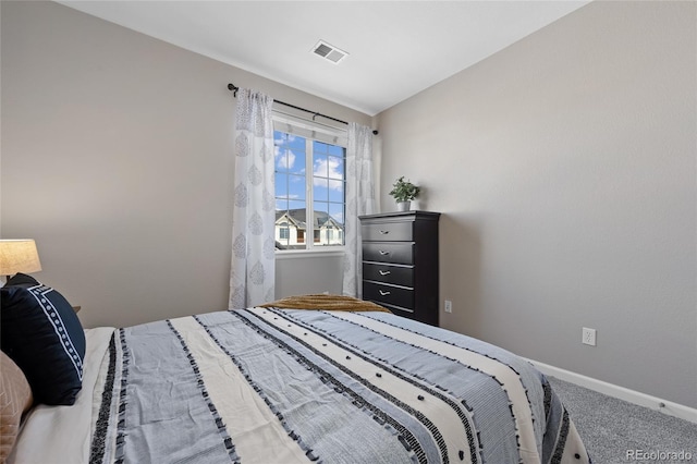 carpeted bedroom with visible vents and baseboards