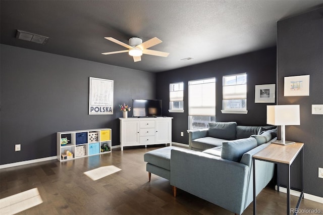 living room with ceiling fan and dark hardwood / wood-style floors