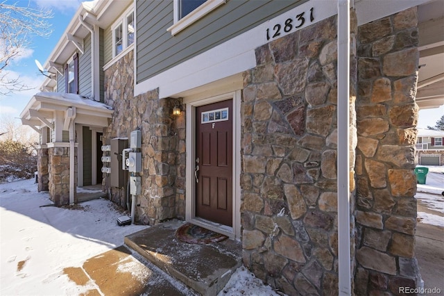 view of snow covered property entrance