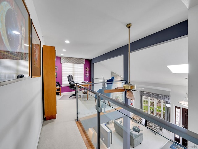 hall with recessed lighting, baseboards, and a skylight