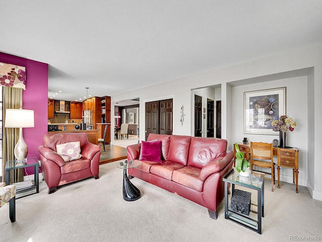 living area featuring recessed lighting, baseboards, and light carpet