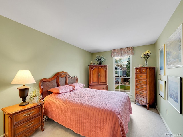 bedroom featuring baseboards and light carpet