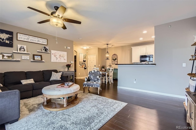 living room with a ceiling fan, baseboards, dark wood finished floors, and recessed lighting