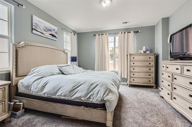 bedroom featuring visible vents and carpet