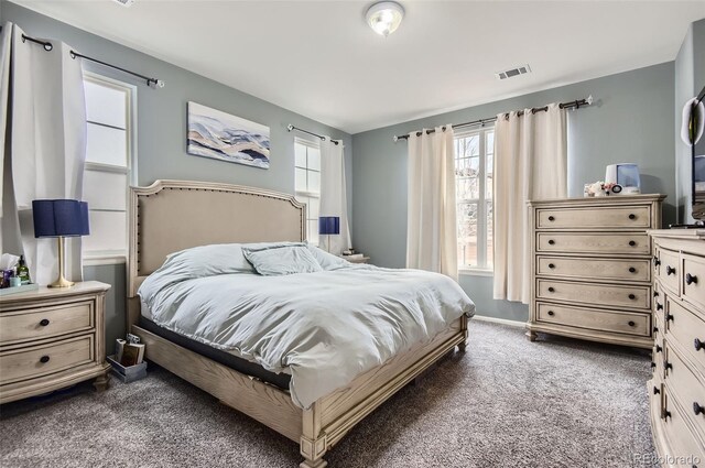 bedroom with visible vents and dark colored carpet