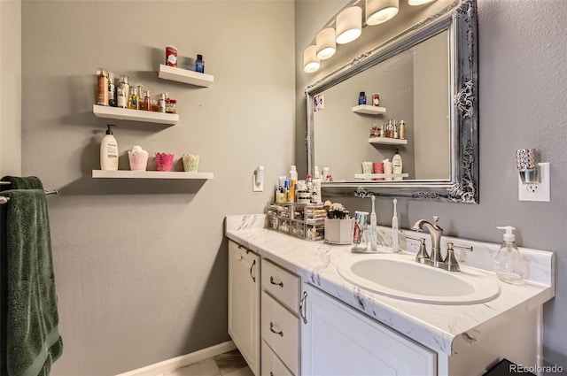 bathroom with vanity and baseboards