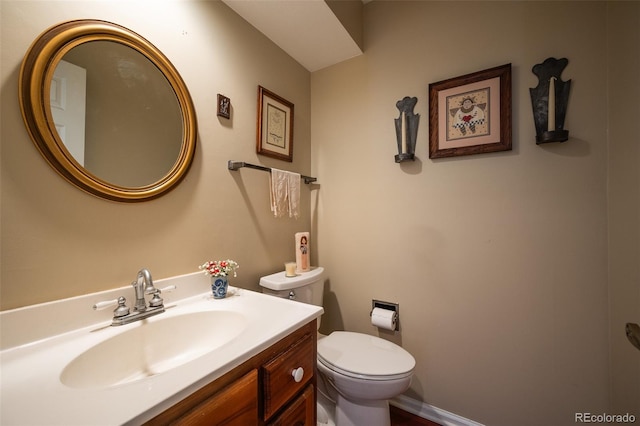 bathroom featuring toilet and vanity