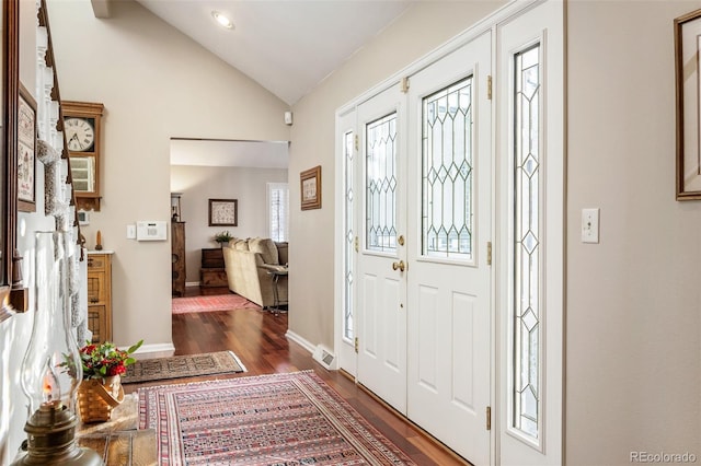 foyer entrance featuring dark hardwood / wood-style flooring and vaulted ceiling