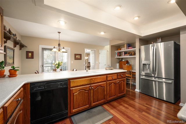 kitchen with sink, black dishwasher, hanging light fixtures, stainless steel fridge with ice dispenser, and dark wood-type flooring