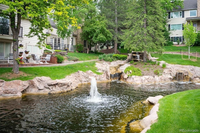 view of community with a water view