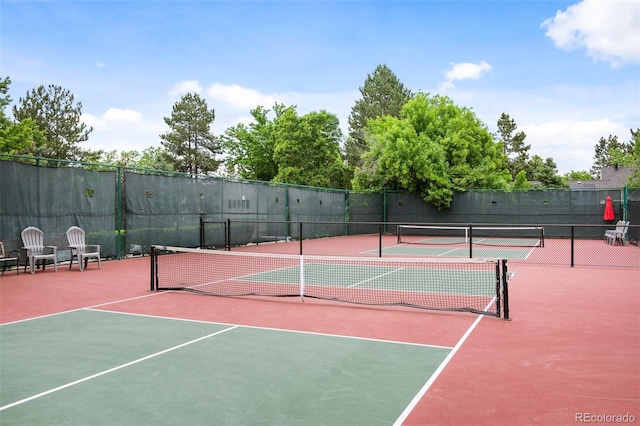 view of tennis court with basketball hoop