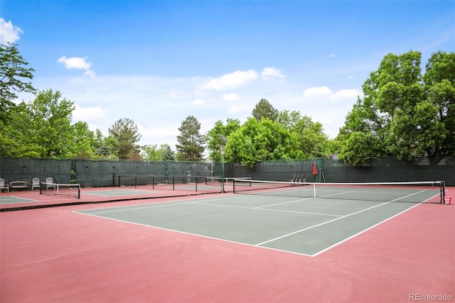 view of tennis court featuring basketball hoop