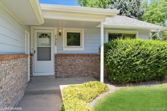 7325 S Houstoun Waring Cir, Littleton, CO 80120 - property entrance featuring brick siding and a shingled roof