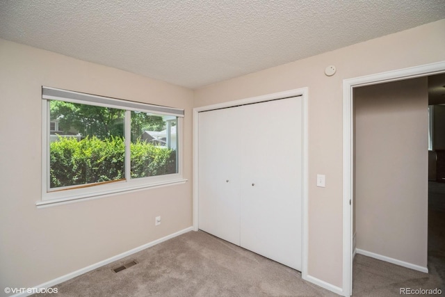 7325 S Houstoun Waring Cir, Littleton, CO 80120 - unfurnished bedroom featuring carpet floors, a closet, and a textured ceiling