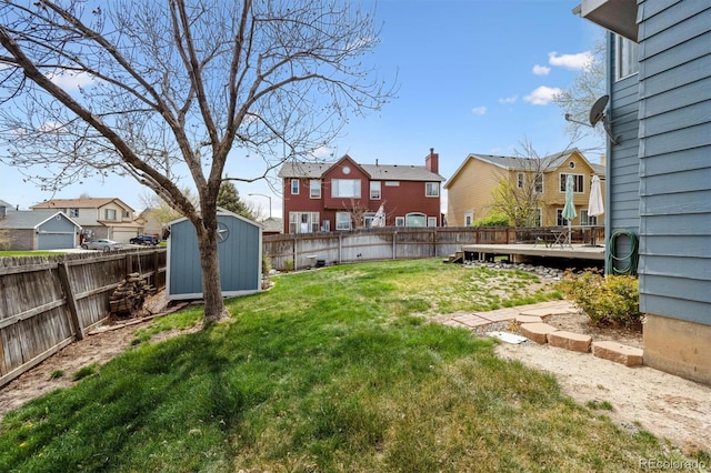 4290 Cottonwood Lakes Blvd, Thornton, CO 80241 - view of yard featuring a residential view, a storage shed, a wooden deck, a fenced backyard, and an outbuilding